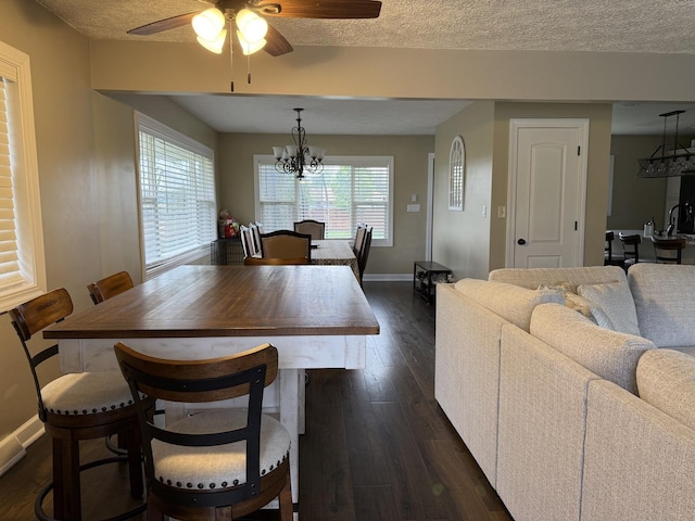 1401 Clement St, Joliet, IL 60435 - dining area featuring a ceiling fan, baseboards, dark wood-type flooring, a chandelier, and a textured ceiling