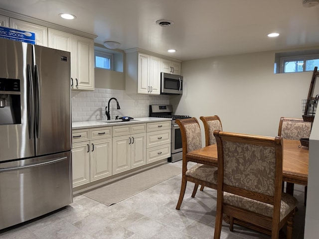 1401 Clement St, Joliet, IL 60435 - kitchen with appliances with stainless steel finishes, a sink, light countertops, healthy amount of natural light, and recessed lighting