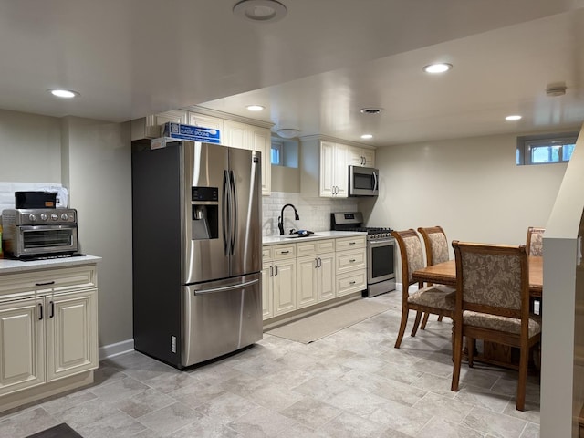 1401 Clement St, Joliet, IL 60435 - kitchen with appliances with stainless steel finishes, light countertops, backsplash, recessed lighting, and a sink