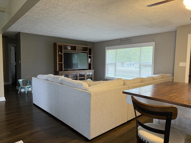 1401 Clement St, Joliet, IL 60435 - living area featuring dark wood-style floors, a textured ceiling, and a ceiling fan