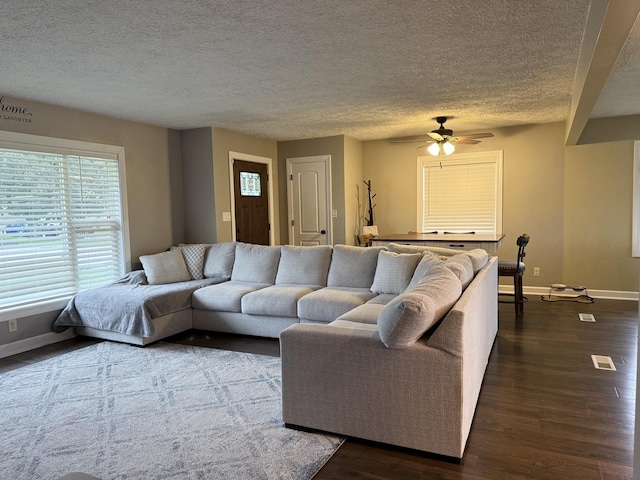 1401 Clement St, Joliet, IL 60435 - living area featuring baseboards, a ceiling fan, dark wood-style floors, and a textured ceiling