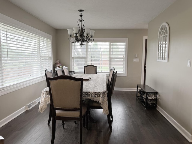 1401 Clement St, Joliet, IL 60435 - dining space featuring a chandelier, dark wood-style flooring, and baseboards