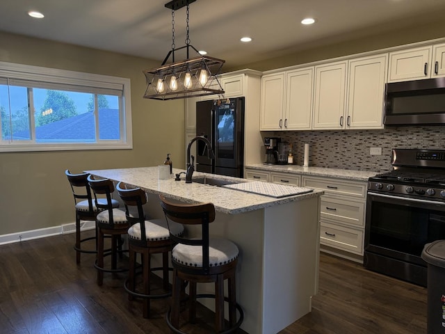 1401 Clement St, Joliet, IL 60435 - kitchen with black appliances, recessed lighting, white cabinets, light stone counters, and tasteful backsplash