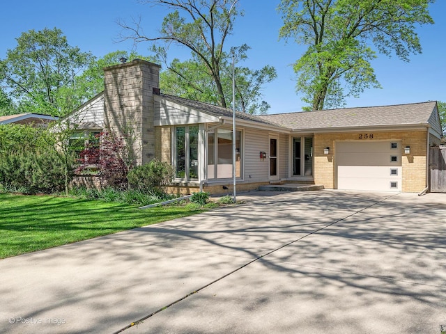 258 S Boyd Ave, Elmhurst, IL 60126 - view of front of house featuring a garage, brick siding, driveway, and a chimney