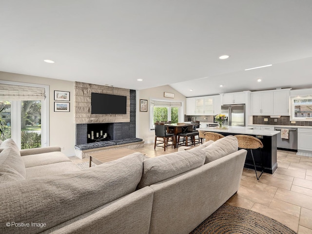 258 S Boyd Ave, Elmhurst, IL 60126 - living area featuring healthy amount of natural light, a stone fireplace, vaulted ceiling, and recessed lighting