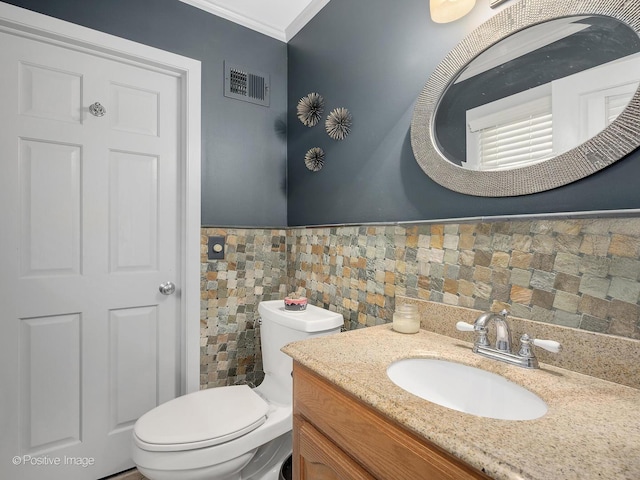 258 S Boyd Ave, Elmhurst, IL 60126 - bathroom featuring toilet, crown molding, vanity, wainscoting, and tile walls