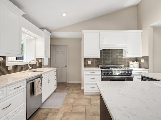 258 S Boyd Ave, Elmhurst, IL 60126 - kitchen featuring appliances with stainless steel finishes, a sink, vaulted ceiling, backsplash, and white cabinetry