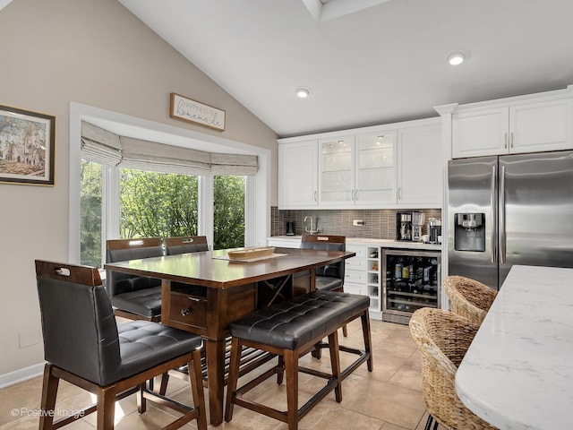 258 S Boyd Ave, Elmhurst, IL 60126 - kitchen with stainless steel fridge with ice dispenser, wine cooler, white cabinetry, backsplash, and vaulted ceiling