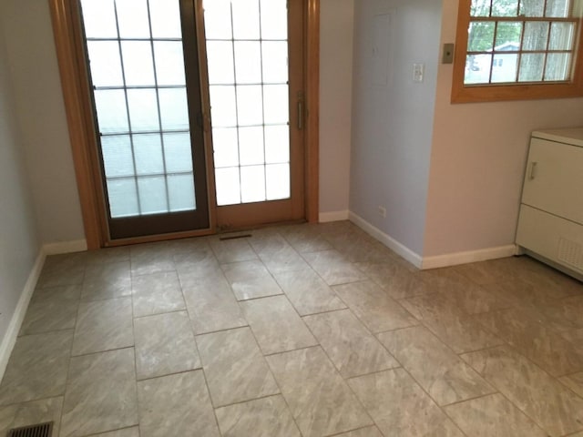 2307 Jay Ln, Rolling Meadows, IL 60008 - doorway to outside with baseboards, washer / dryer, and light tile patterned floors