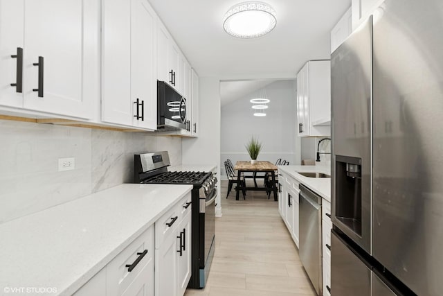 1220 E Rockwell St, Arlington Heights, IL 60005 - kitchen featuring appliances with stainless steel finishes, a sink, light countertops, and white cabinetry