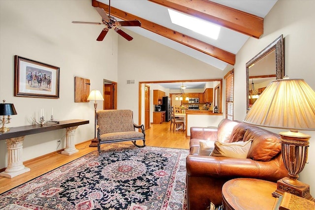 2551 Doncaster Dr, Aurora, IL 60504 - living area featuring light wood finished floors, a ceiling fan, beam ceiling, a skylight, and high vaulted ceiling