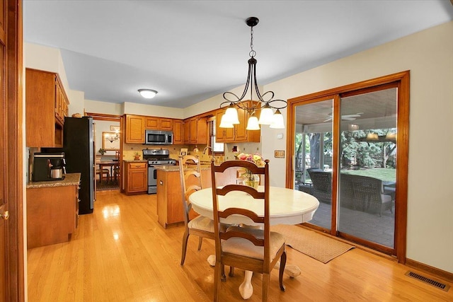 2551 Doncaster Dr, Aurora, IL 60504 - dining space featuring light wood finished floors and a chandelier
