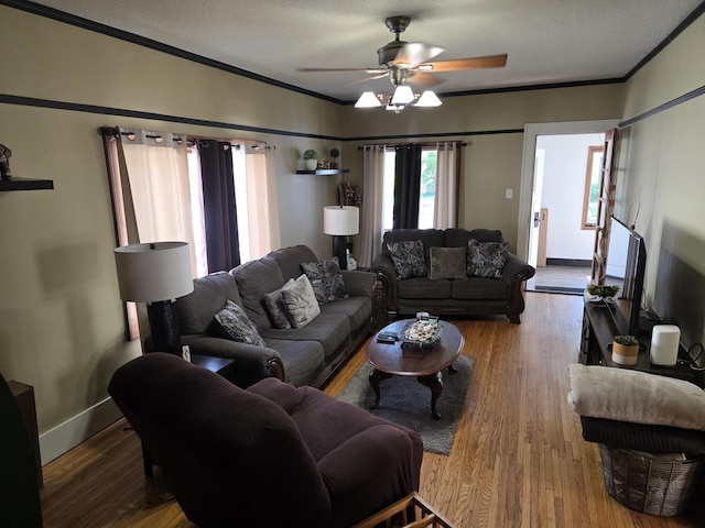6101/2 W 7th St, Sterling, IL 61081 - living room featuring ornamental molding, ceiling fan, baseboards, and wood finished floors