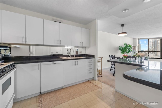 405 N Wabash Ave Unit 2314, Chicago, IL 60611 - kitchen featuring a sink, white appliances, a textured ceiling, white cabinetry, and dark countertops