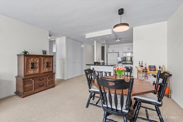 405 N Wabash Ave Unit 2314, Chicago, IL 60611 - dining space with light colored carpet and a textured ceiling