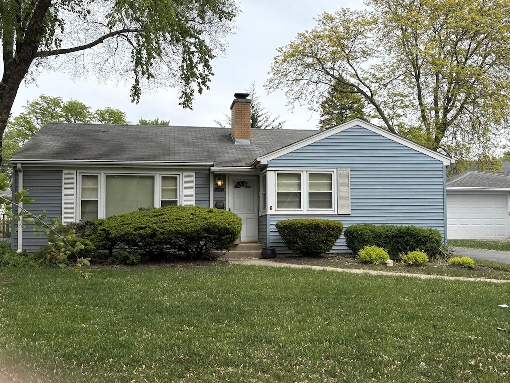 159 S Brockway St, Palatine, IL 60067 - view of front of house with a chimney, a front lawn, and a detached garage