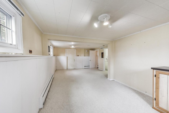 708 S Edgewood Ln, Mount Prospect, IL 60056 - below grade area featuring a baseboard heating unit, crown molding, light colored carpet, and baseboard heating