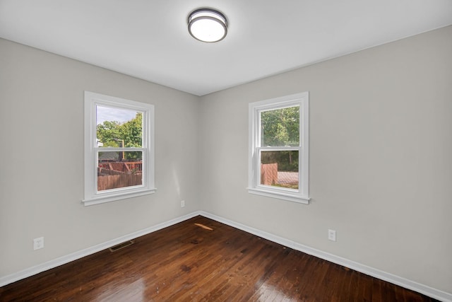 402 Miami St, Joliet, IL 60432 - unfurnished room with baseboards and dark wood-type flooring