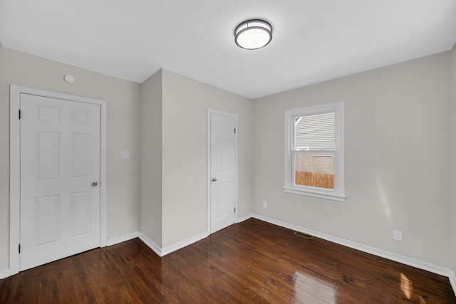 402 Miami St, Joliet, IL 60432 - unfurnished bedroom featuring wood-type flooring and baseboards