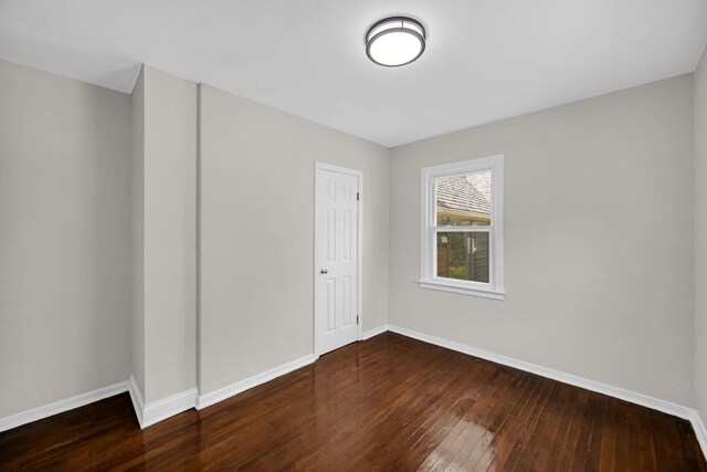402 Miami St, Joliet, IL 60432 - unfurnished bedroom featuring hardwood / wood-style floors, baseboards, and a closet