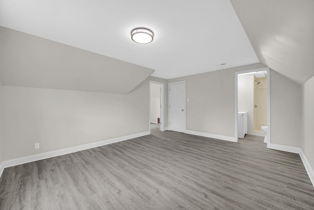 402 Miami St, Joliet, IL 60432 - additional living space with vaulted ceiling, wood finished floors, and baseboards