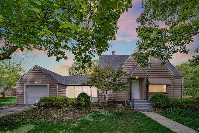402 Miami St, Joliet, IL 60432 - view of front facade featuring roof with shingles, a chimney, an attached garage, and driveway
