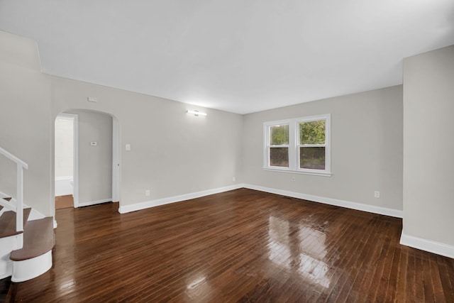 402 Miami St, Joliet, IL 60432 - spare room with arched walkways, wood-type flooring, stairs, and baseboards