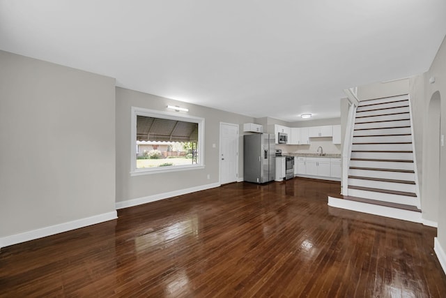 402 Miami St, Joliet, IL 60432 - unfurnished living room with a sink, dark wood-type flooring, baseboards, and stairs