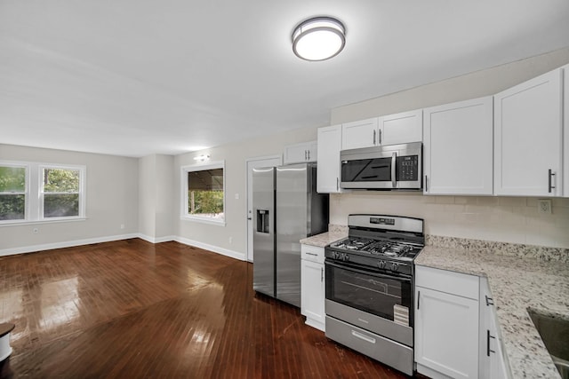 402 Miami St, Joliet, IL 60432 - kitchen with stainless steel appliances, dark wood-style flooring, baseboards, and plenty of natural light