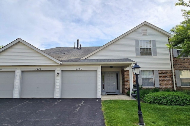 1338 Stratford Dr Unit 1338, Gurnee, IL 60031 - view of front of house featuring brick siding and a shingled roof