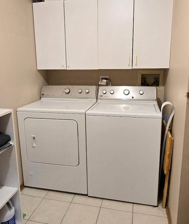 1338 Stratford Dr Unit 1338, Gurnee, IL 60031 - laundry room with washing machine and dryer, cabinet space, and light tile patterned floors
