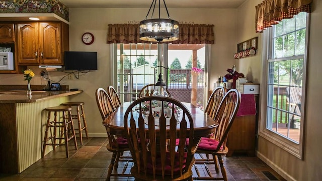 29 N Deer Lk N, Villa Grove, IL 61956 - dining area with plenty of natural light, baseboards, and a chandelier