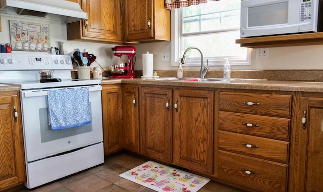 29 N Deer Lk N, Villa Grove, IL 61956 - kitchen featuring white appliances, exhaust hood, a sink, and brown cabinets