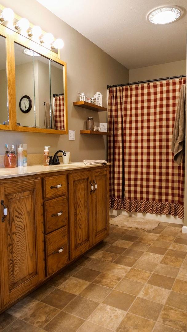 29 N Deer Lk N, Villa Grove, IL 61956 - bathroom with vanity and curtained shower