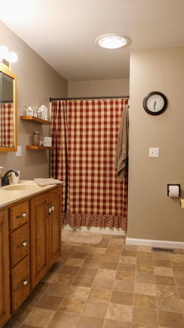 29 N Deer Lk N, Villa Grove, IL 61956 - full bathroom with vanity and curtained shower