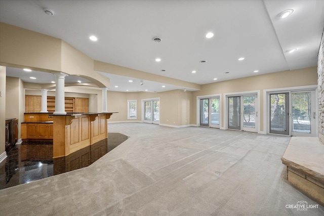53 Abbeyfeale Dr, Oswego, IL 60543 - unfurnished living room with ornate columns, baseboards, recessed lighting, and light colored carpet