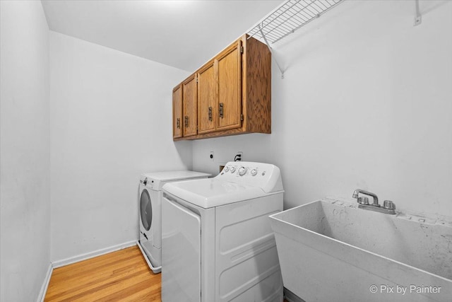 39W889 Deer Run Dr, Saint Charles, IL 60175 - washroom featuring cabinet space, washing machine and clothes dryer, light wood-type flooring, and baseboards