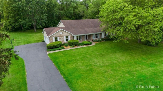 39W889 Deer Run Dr, Saint Charles, IL 60175 - single story home with driveway, covered porch, a front yard, an attached garage, and stone siding