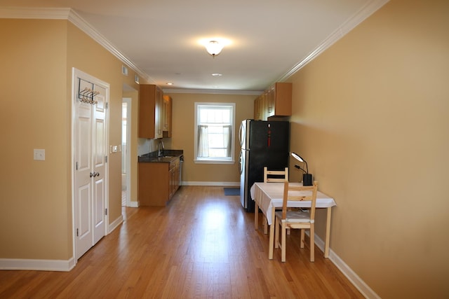 1615 Monroe St Unit 3N, Evanston, IL 60202 - kitchen with freestanding refrigerator, light wood-style flooring, baseboards, ornamental molding, and dark countertops