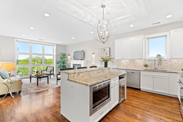 2431 W Belmont Ave Unit 3E, Chicago, IL 60618 - kitchen featuring appliances with stainless steel finishes, a sink, light stone countertops, white cabinetry, and recessed lighting