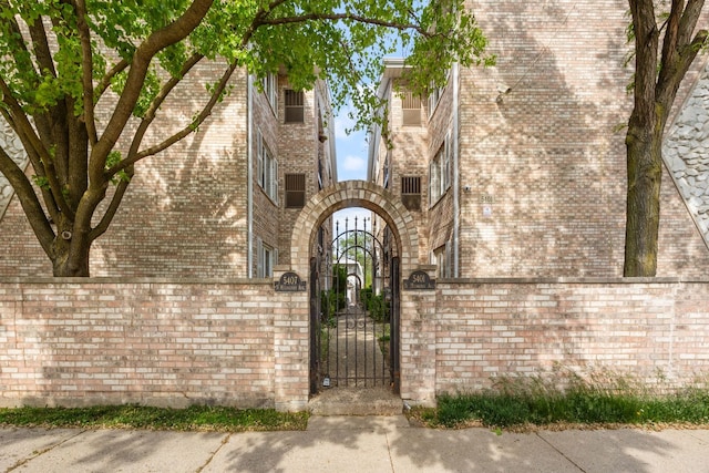 5401 N Milwaukee Ave Unit 1A, Chicago, IL 60630 - view of exterior entry with a gate and brick siding