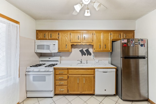 5401 N Milwaukee Ave Unit 1A, Chicago, IL 60630 - kitchen with white appliances, a sink, light countertops, and brown cabinetry