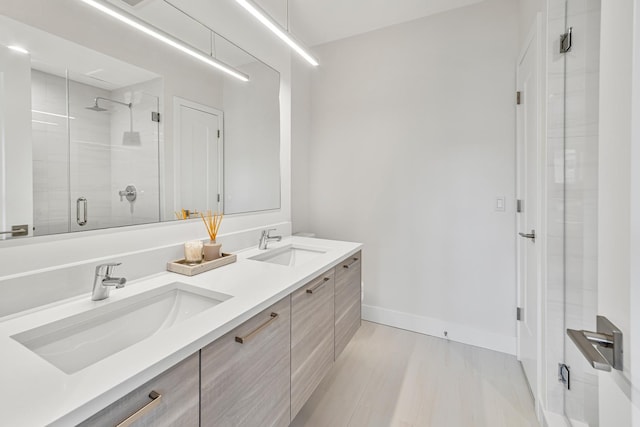 4906 N Kenmore Ave Unit 2S, Chicago, IL 60640 - bathroom with a stall shower, double vanity, and baseboards