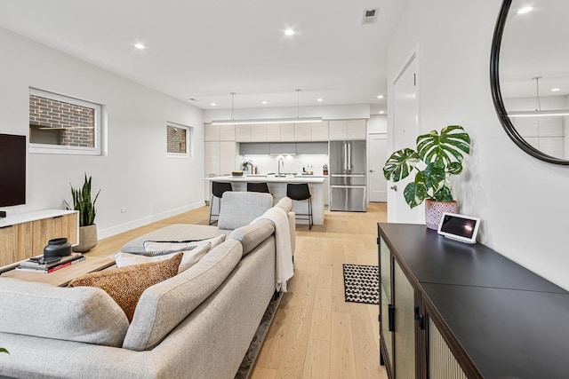 4906 N Kenmore Ave Unit 2S, Chicago, IL 60640 - living room with light wood-style floors, baseboards, and recessed lighting