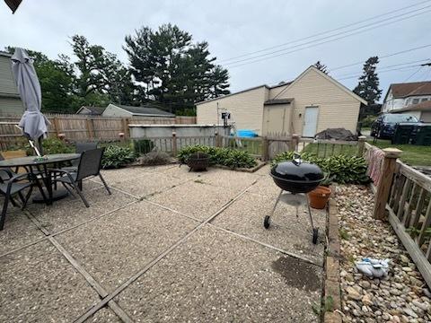 309 11th Ave, Sterling, IL 61081 - fenced backyard with a patio, outdoor dining area, and a grill