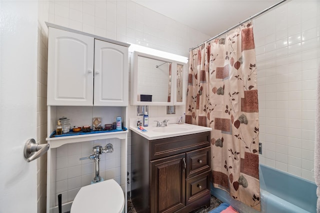 6157 N Sheridan Rd Unit 5G, Chicago, IL 60660 - bathroom featuring vanity, shower / bath combo with shower curtain, tile walls, and toilet