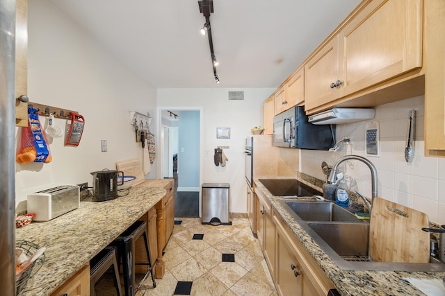 6157 N Sheridan Rd Unit 5G, Chicago, IL 60660 - kitchen with light brown cabinetry, a sink, black appliances, backsplash, and light stone counters