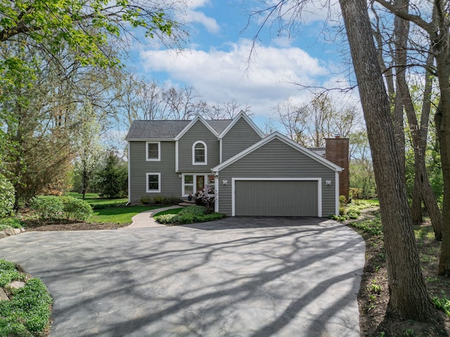 22585 N Ruth Ct, Kildeer, IL 60047 - view of front of house featuring asphalt driveway, an attached garage, and a chimney