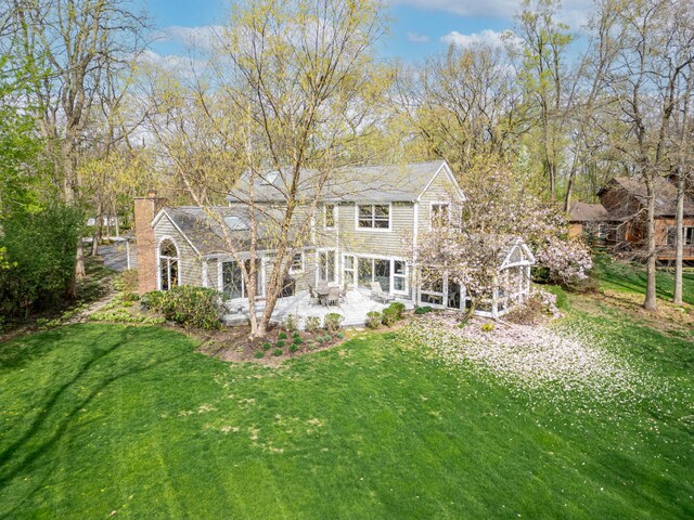 22585 N Ruth Ct, Kildeer, IL 60047 - rear view of house featuring a patio area, a yard, and a chimney