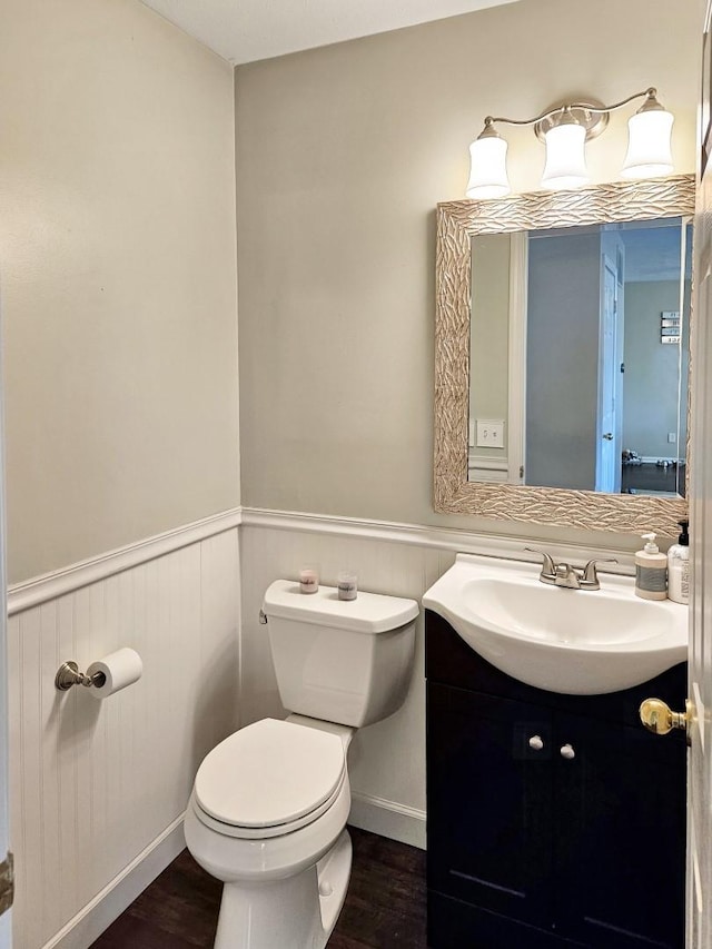 1409 Hull St, Normal, IL 61761 - half bath featuring toilet, wainscoting, vanity, and wood finished floors